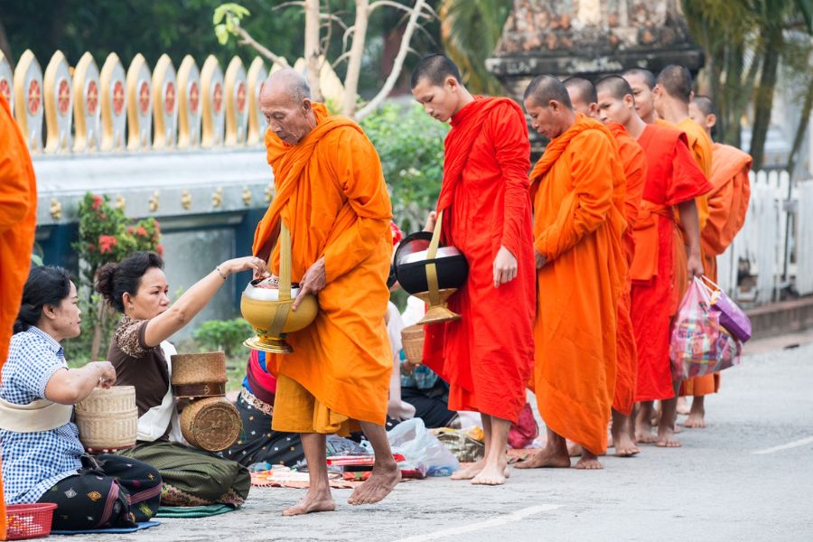 Monk procession during the morning Tak Bat ceremony in Luang Prabang.