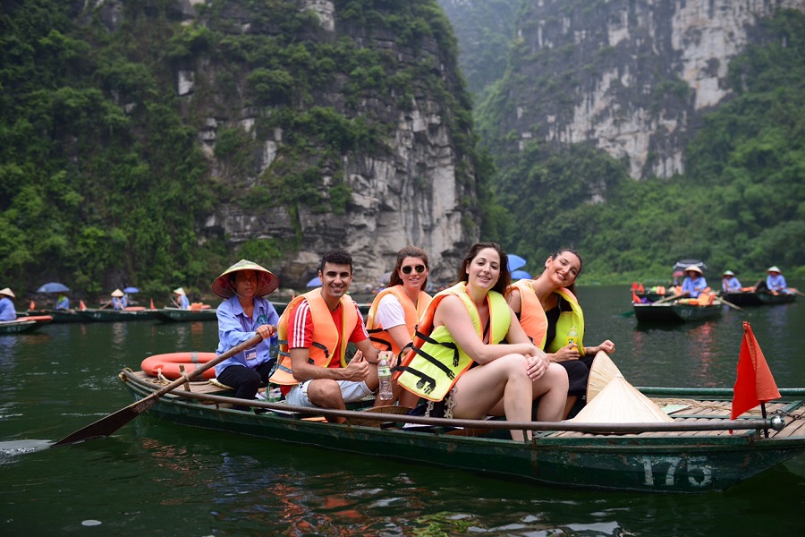 Tourists enjoy exploring the Trang An Complex by waterway
