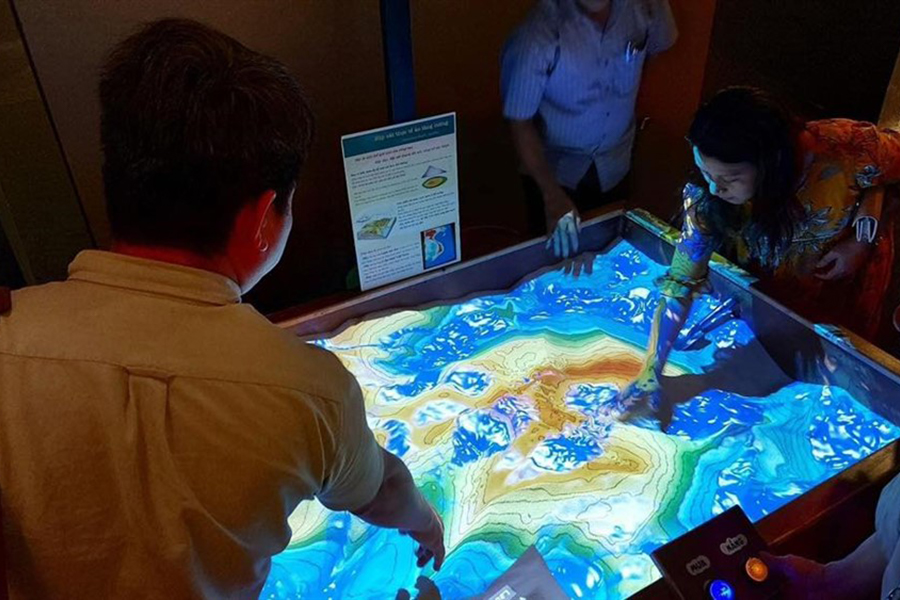Visitors explore real-time terrain changes with an interactive AR sandbox