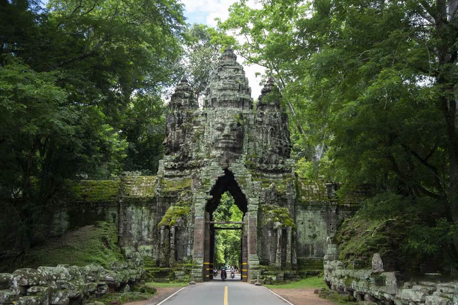  The Angkor Thom complex is fortified by an impressive wall and can be accessed through five monumental entrance gates, each strategically placed at one of the cardinal points