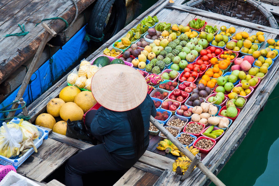 Exploring the fruit market on the river, particularly at Cai Rang Floating Market in Can Tho, is a captivating experience