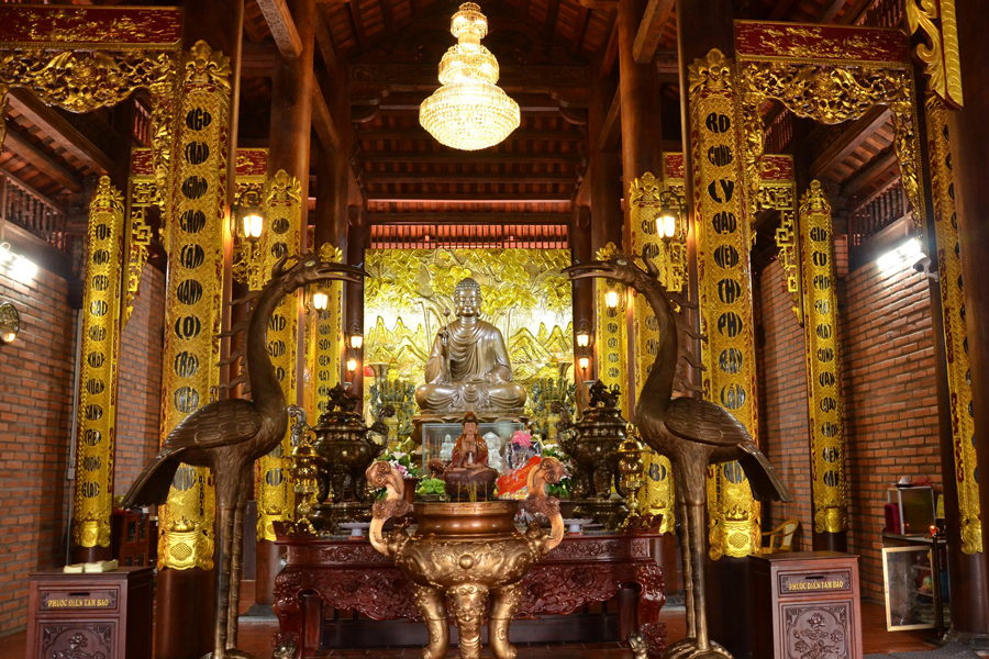 The main hall is tiled with four roofs, curved in the shape of a boat's bow in the style of the Ly Dynasty