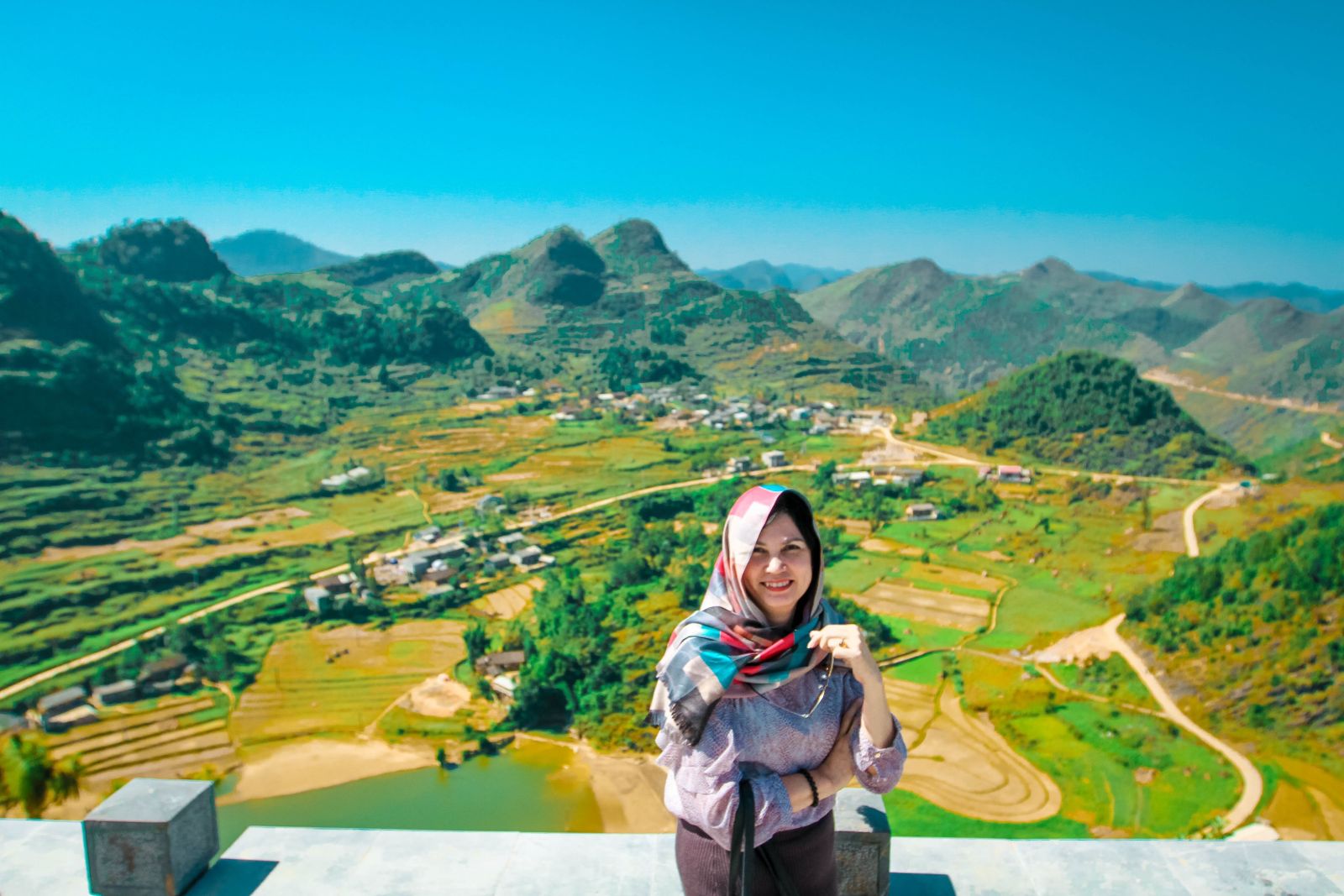 Tourist takes photo with Quan Ba twin mountains