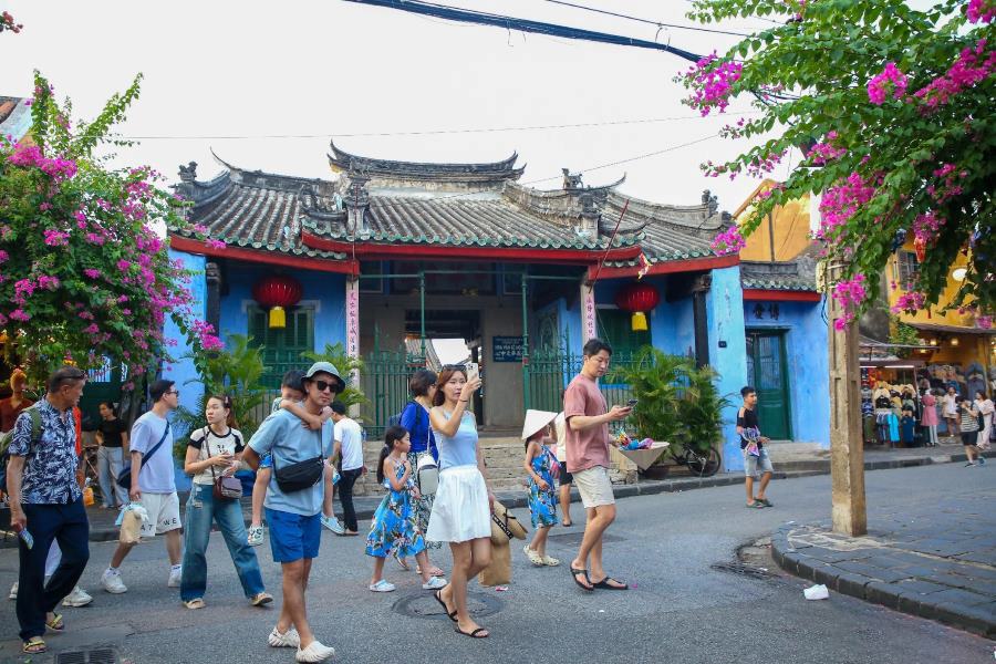 Tourists stroll along the Hoi An streets