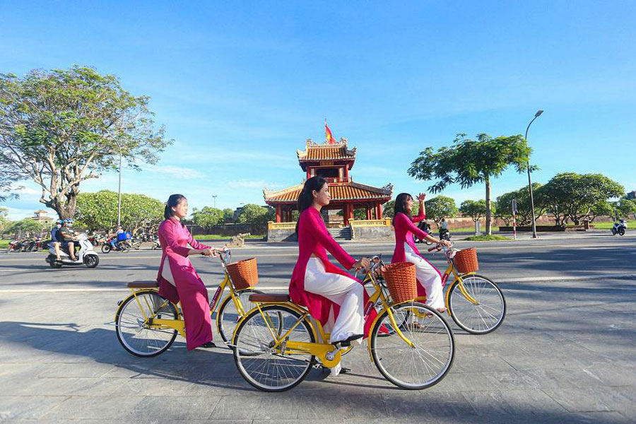 Charming Vietnamese girl on a bicycle