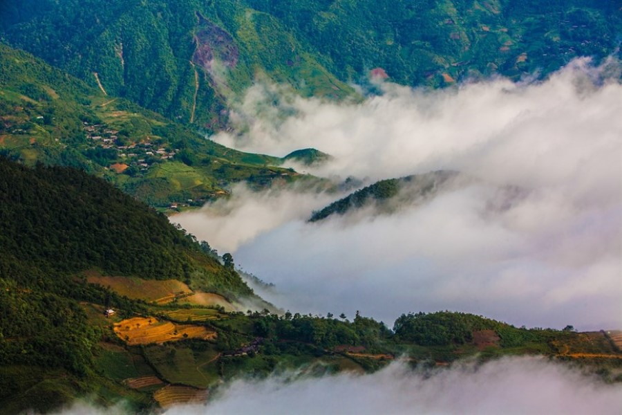 Fluffy clouds cover almost all of the villages at the bottom of Khau Pha Pass