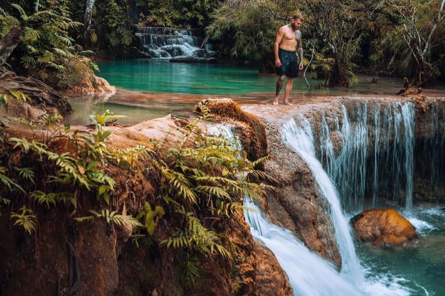 Hiking at Kuang Si Falls offers an immersive experience in the pristine beauty
