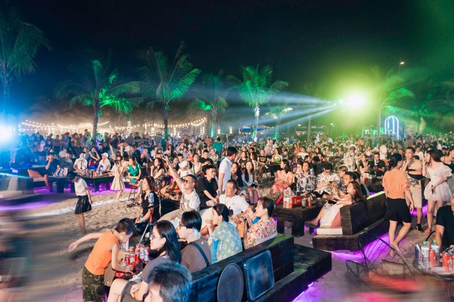 Outdoor seating with vibrant lighting at a Ha Long bar 