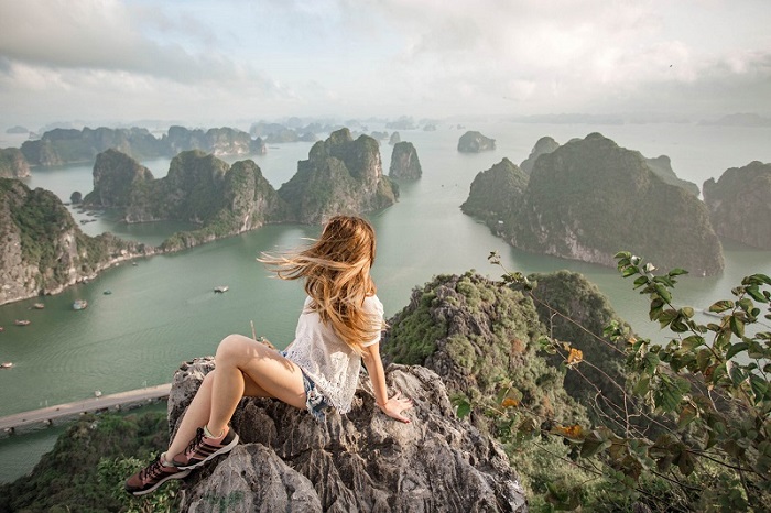 Tourist takes photo on the top of Bai Tho mountain