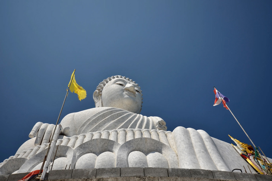 Prayer flags are a colorful and symbolic feature commonly found in Buddhist temples, including the temple complex surrounding the Big Buddha Statue in Phuket