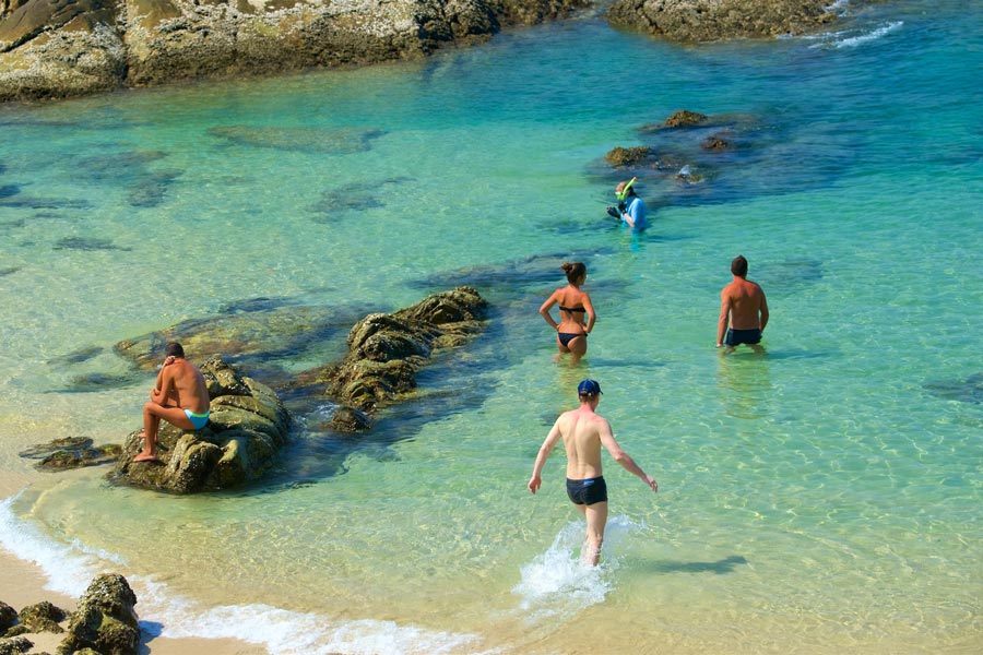 Patong Beach is characterized by its long crescent-shaped shoreline with golden sands and clear blue waters