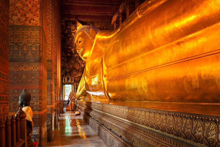 The Reclining Buddha, known as Phra Buddhasaiyas in Thai, is the crowning jewel and a major focal point of Wat Pho in Bangkok