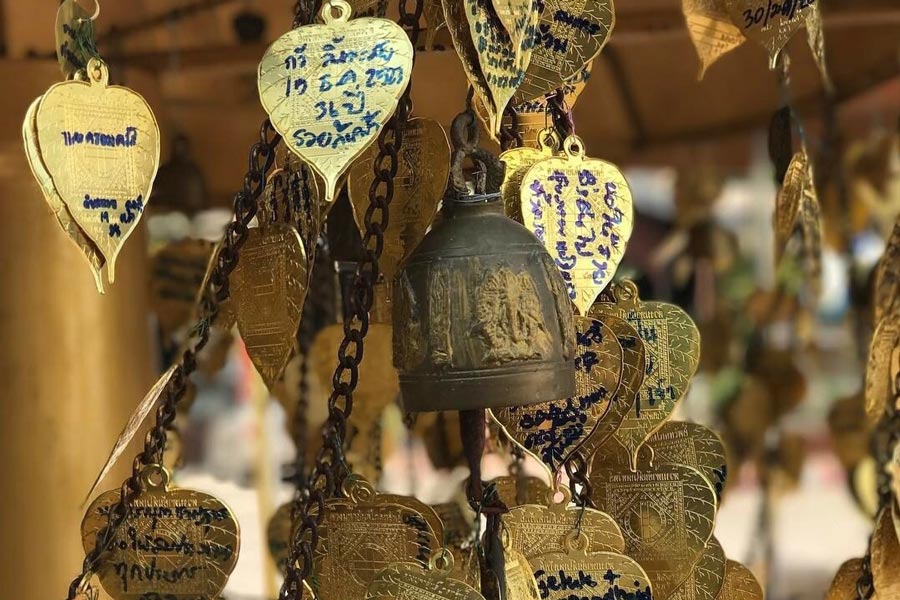 While specific details about the bells at Wat Phra That Doi Kong Mu may vary, many Buddhist temples incorporate bells into their structures for symbolic and ceremonial purposes