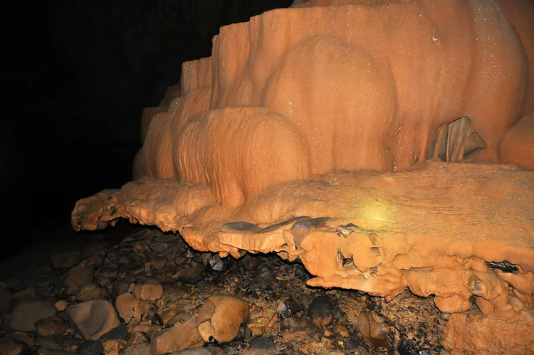 Inside the cave, there are stalactites and stalagmites scattered throughout the cave