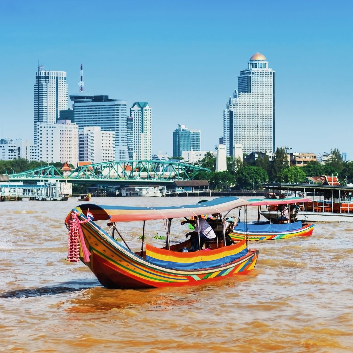 A couple of longtail boats carrying tourists on&nbsp;the Chao Phraya River
