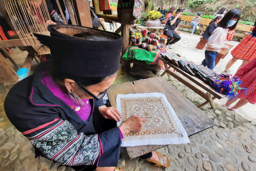 A Hmong woman is embroidering traditional textile patterns. Photo: Dan toc va phat trien