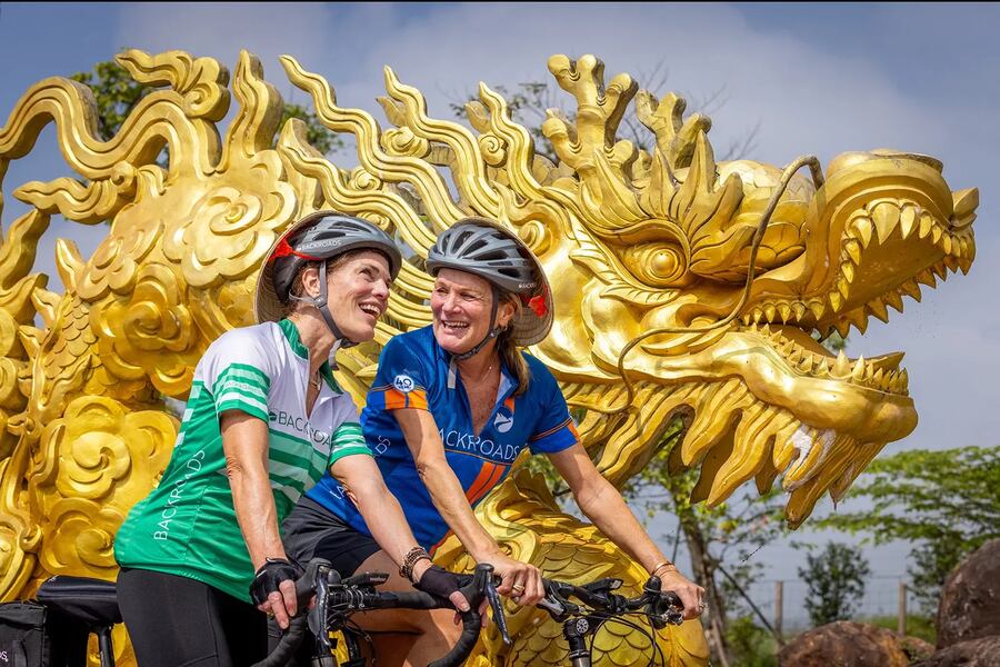 Bonded with a new travel companion on a cycling adventure in Vietnam. Photo: Backroads