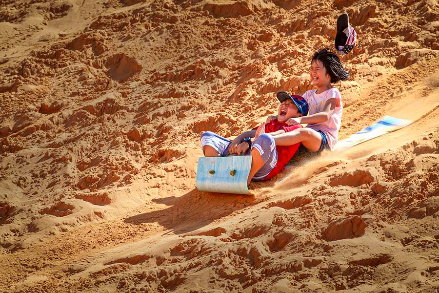 Sandboarding is a fun game for all ages. Source: Binh Thuan Tourism