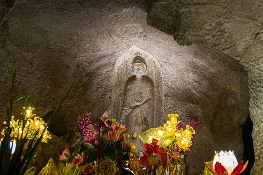 Buddha statue was carved into the cave wall