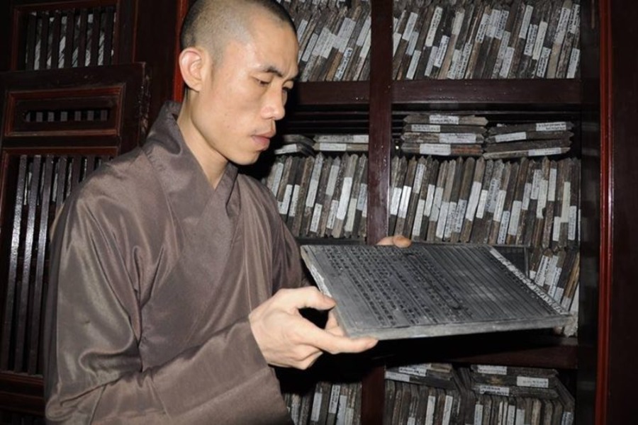 A Buddhist presents a woodblock. Source: Vinh Nghiem Pagoda Web Portal