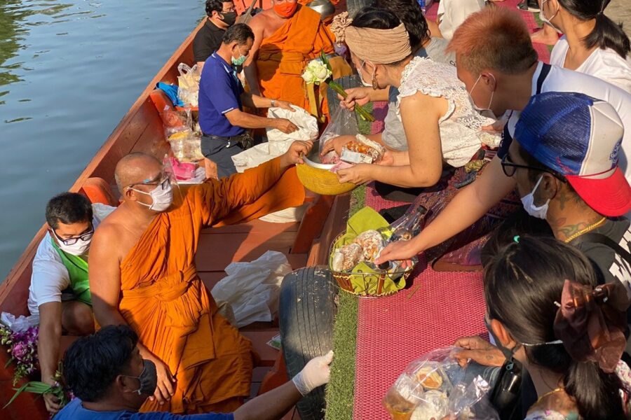 Monks receive offerings from local people. Photo: Richard Barrow