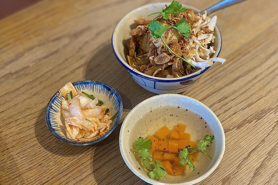 The dish is served with kimchi and carrot soup, which help aid digestion of the sticky rice. Photo: VnExpress