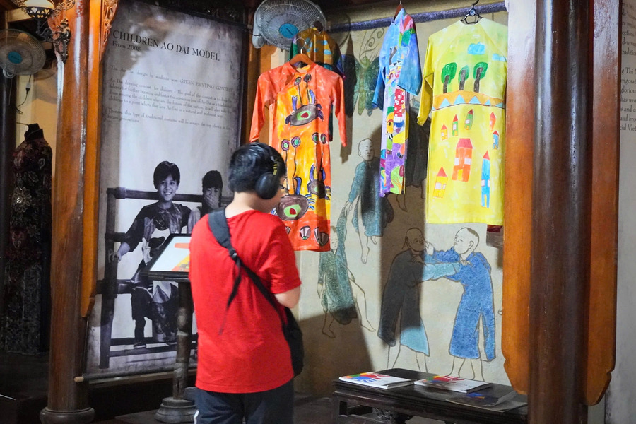 Some designs by children have been sewn into Ao Dai