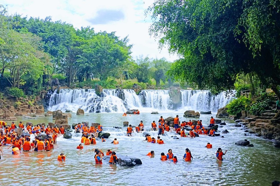 Many tourists come to swim in the waterfall during the holidays