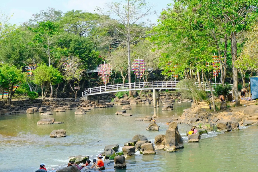 Surrounding the clear, blue stream is a picturesque and tranquil natural landscape