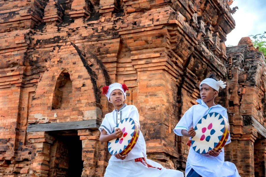 Kate Festival Cham boys playing traditional drums during a cultural performance at a Cham tower