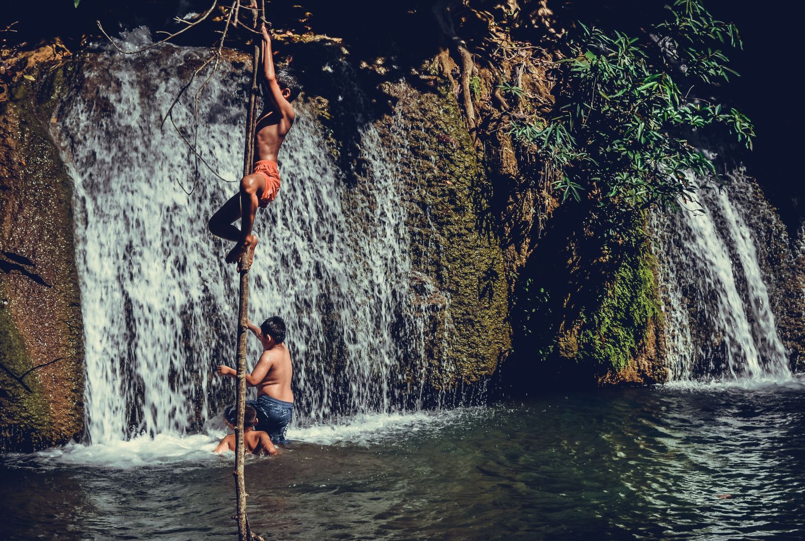 The boys enjoyed a summer day climbing near the waterfall