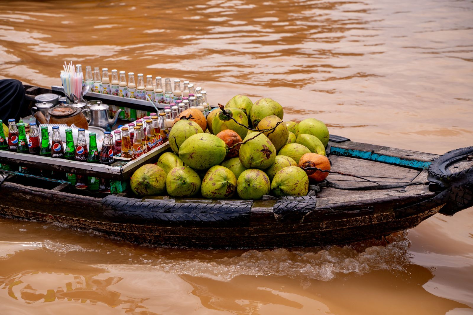 A boat selling coconuts and drinks at Can Tho floating market, Vietnam
