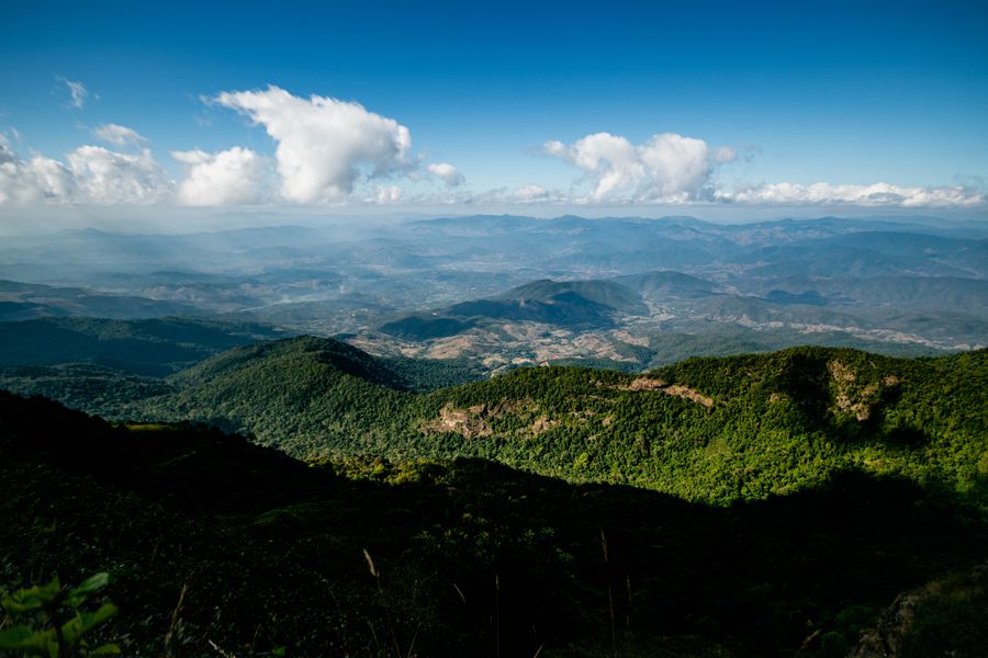 A vast landscape of lush green mountains and clouds in Chiang Dao