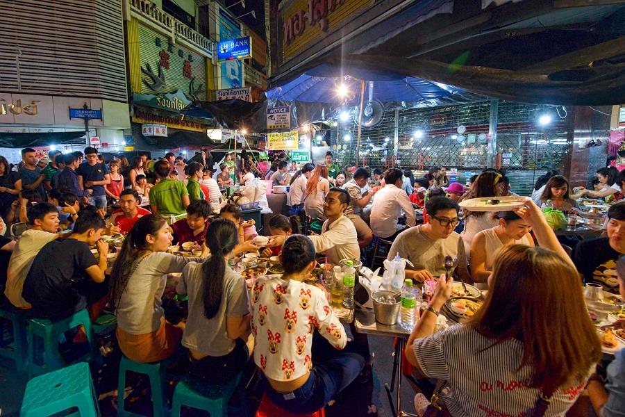 Tourists enjoy delicious street food