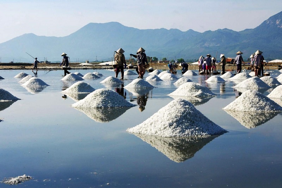 Sa Huynh Salt Field is a vast landscape of reflective waters and interlaced salt dunes stretching to the horizon