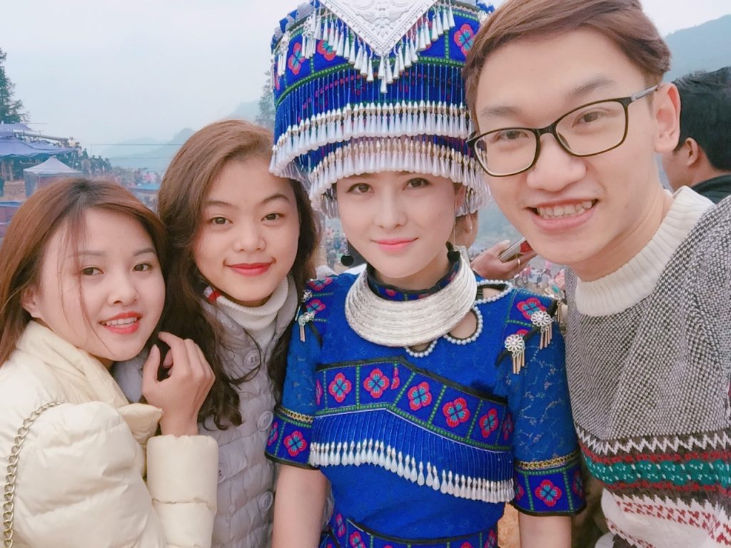 Tourists take photos with colorful traditional costume