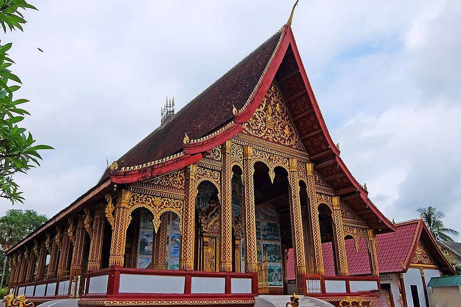 Wat Manorom showcases classic Lao temple architecture with a tiered roof and intricate details
