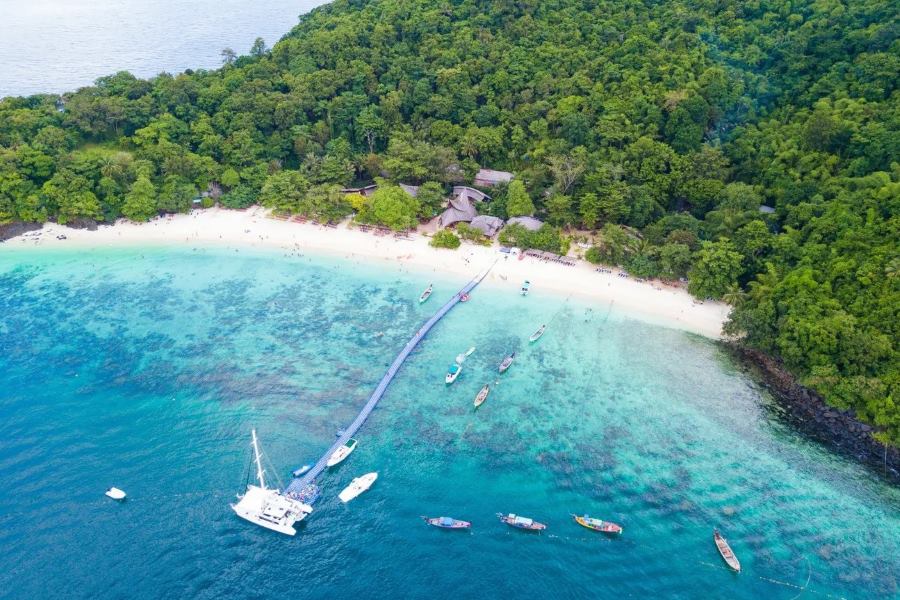 A pristine Banana Beach with a lush green surround