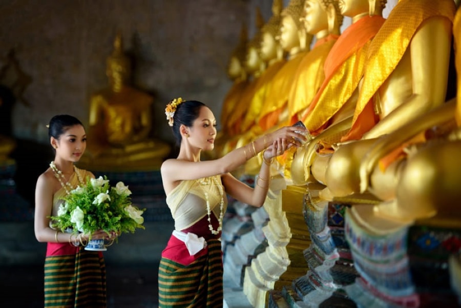 People dress elegantly, offer incense, present flowers at temples