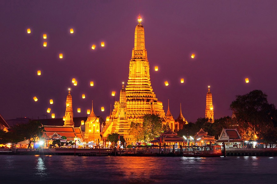 The iconic Temple of Dawn illuminated under a sky full of lanterns